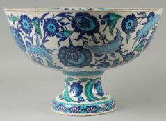 A LARGE TURKISH OTTOMAN GLAZED POTTERY CENTRE PIECE PEDESTAL BOWL, painted with foliate motifs, 42.