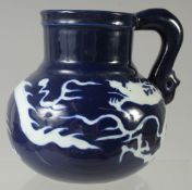 A CHINESE SACRIFICIAL BLUE AND WHITE DRAGON JUG, 14.5cm high.