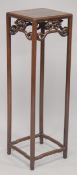 A TALL CHINESE HARDWOOD SQUARE-FORM VASE STAND, with carved skirt and stretchered legs, 111cm high.