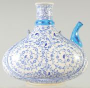 A TURKISH BLUE AND WHITE GLAZED POTTERY WATER JUG, 19cm wide.