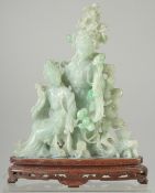 A CHINESE CARVED JADEITE FIGURAL GROUP on hardwood stand, 25.5cm high.