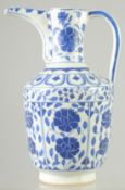 A TURKISH BLUE AND WHITE GLAZED POTTERY WATER JUG, 25.5cm high.