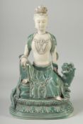 A LARGE CHINESE DEHUA GUANYIN seated upon a lion, 38cm high.