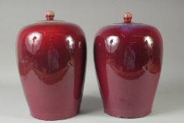 A LARGE PAIR OF CHINESE FLAMBE GLAZE JARS AND COVERS, 31cm high (slightly differ in height).
