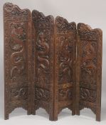 A SUPERB KASHMIRI / CHINESE CARVED FOUR PANEL SCREEN, beautifully carved with panels of dragons; the
