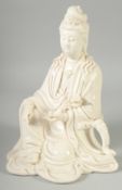A LARGE CHINESE BLANC-DE-CHINE FIGURE OF SEATED GUANYIN, holding a ruyi scepter, 28cm high.