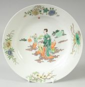 A CHINESE FAMILLE VERTE PORCELAIN PLATE, painted with a female and boys, red six-character mark to