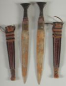 TWO DAGGERS IN LEATHER SHEATHS, (2).