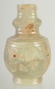 A FINE CARVED JADE BOTTLE, inset with small stones, 9cm high.