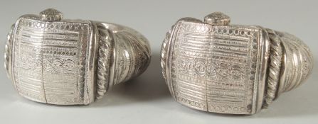 A PAIR OF ISLAMIC SILVER SLAVE BANGLES, with embossed and chased decoration, weight 810G.