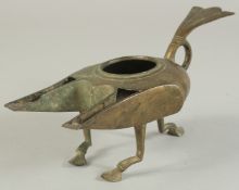 A RARE 12TH-13TH CENTURY ANDALUSIAN SPANISH ALMOHAD BRONZE DOUBLE-SPOUTED OIL LAMP, 23cm long.