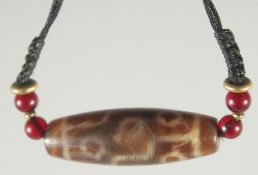A SINGLE DZI BEAD on necklace string.