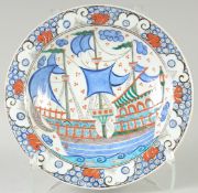 AN OTTOMAN TURKISH IZNIK GLAZED POTTERY PLATE, 31cm diameter.