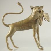 AN ISLAMIC ENGRAVED AND CHASED BRASS FIGURE, 18cm long.