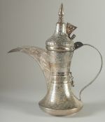 AN ISLAMIC SILVER EWER, with hinged cover and strapwork handle, curving spout, all with punched