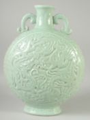 A FINE AND LARGE CELADON GLAZED CARVED DRAGON TWIN HANDLE MOON FLASK, the base with incised