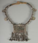 AN ISLAMIC SILVER AND GILT METAL MARRIAGE NECKLACE, with four Islamic coins attached.