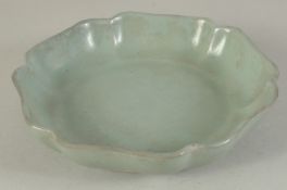 A CHINESE CELADON GLAZE PETAL-FORM DISH, 18cm wide.