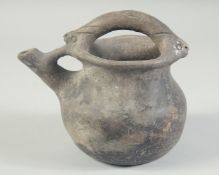 A 10TH CENTURY MIDDLE EASTERN UNGLAZED BLACK POT, with spout and handle, 17cm high.