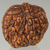 A CHINESE CARVED WALNUT.