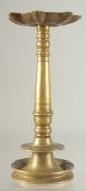 AN ISLAMIC BRASS OIL LAMP, inscribed to rim, 23cm high