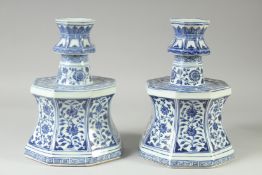 A LARGE PAIR OF CHINESE BLUE AND WHITE PORCELAIN CANDLESTICKS, decorated with panels of flora,