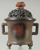 A CHINESE QING DYNASTY BRONZE CENSER AND HARDWOOD COVER, with soapstone finial, 17cm high.
