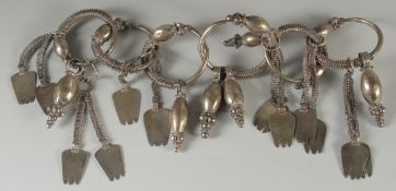 AN ISLAMIC SILVER MARRIAGE NECKLACE, comprising six conjoined hoops, each with barbed and lobed