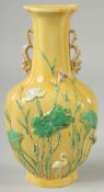 A CHINESE QING DYNASTY YELLOW GROUND SANCAI PORCELAIN WALL-POCKET VASE, with fine moulded chilong