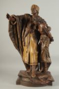 A 19TH CENTURY TERRACOTTA STATUE OF AN ARAB MAN AND LADY, signed H. Moreau, 68cm high.