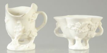 TWO BLANC-DE-CHINE BEAKERS, with relief floral decoration, 7.5cm and 5cm high.