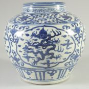 A CHINESE BLUE AND WHITE PORCELAIN JAR, with panels of dragons and phoenix, 23cm high.
