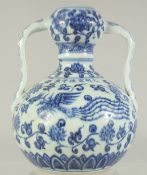 A CHINESE BLUE AND WHITE PORCELAIN TWIN HANDLE VASE, decorated with phoenix and lotus, 20.5cm high.