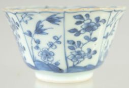 A CHINESE KANGXI BLUE AND WHITE PORCELAIN TEA BOWL, painted with panels of flora, interior with