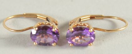 A PAIR OF GOLD AMETHYST EARRINGS.