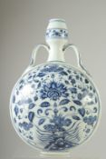 A CHINESE BLUE AND WHITE PORCELAIN TWIN HANDLE MOON FLASK, painted with central floral spray.