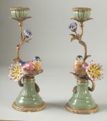 A PAIR OF PORCELAIN AND GILT METAL BIRD CANDLESTICKS with flowers. 12ins high.