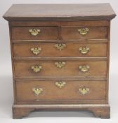 AN 18TH CENTURY OAK STRAIGHT FRONT CHEST of two short and three long graduated drawers with brass