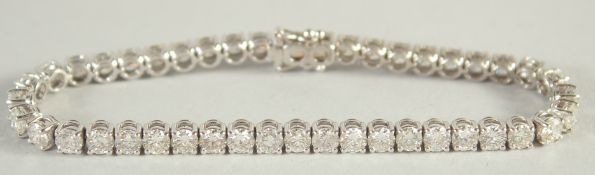 AN 18CT WHITE GOLD AND DIAMOND LINE BRACELET with 10.5 carats of diamonds.