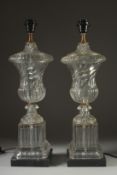 A PAIR OF GLASS URN LAMPS on square bases. 24ins high.