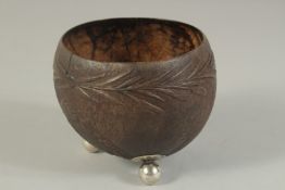 A CARVED COCONUT BOWL on ball feet.