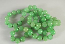A GOOD STRING OF SIXTY SIX BEADS. 30ins long