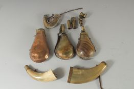 A BAG OF VARIOUS POWDER HORNS AND PIECES.