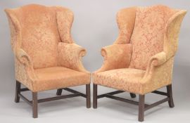 A PAIR OF GEORGIAN MANNER MAHOGANY FRAMED WING ARM CHAIRS on plain mahogany legs.