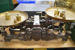A GOOD SET OF CAST IRON SCALES with brass pans and weights.