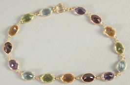 AN 18CT YELLOW GOLD MULTI GEM SET BRACELET.