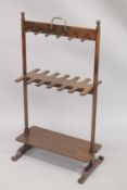 A RARE 19TH CENTURY MAHOGANY RACK with twelve segment hanging spaces, with a plain under tier. 3ft