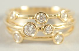 AN 18CT YELLOW GOLD AND DIAMOND THREE BAND 