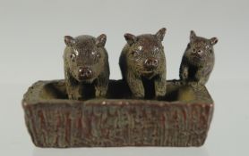 A JAPANESE BRONZE PIGS IN A TROUGH. 4cm.