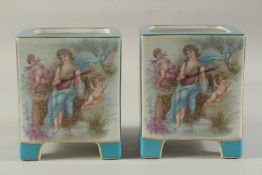 A PAIR OF BLUE SEVRES DESIGN SQUARE CACHES POTS with classical design panel. 7ins high.